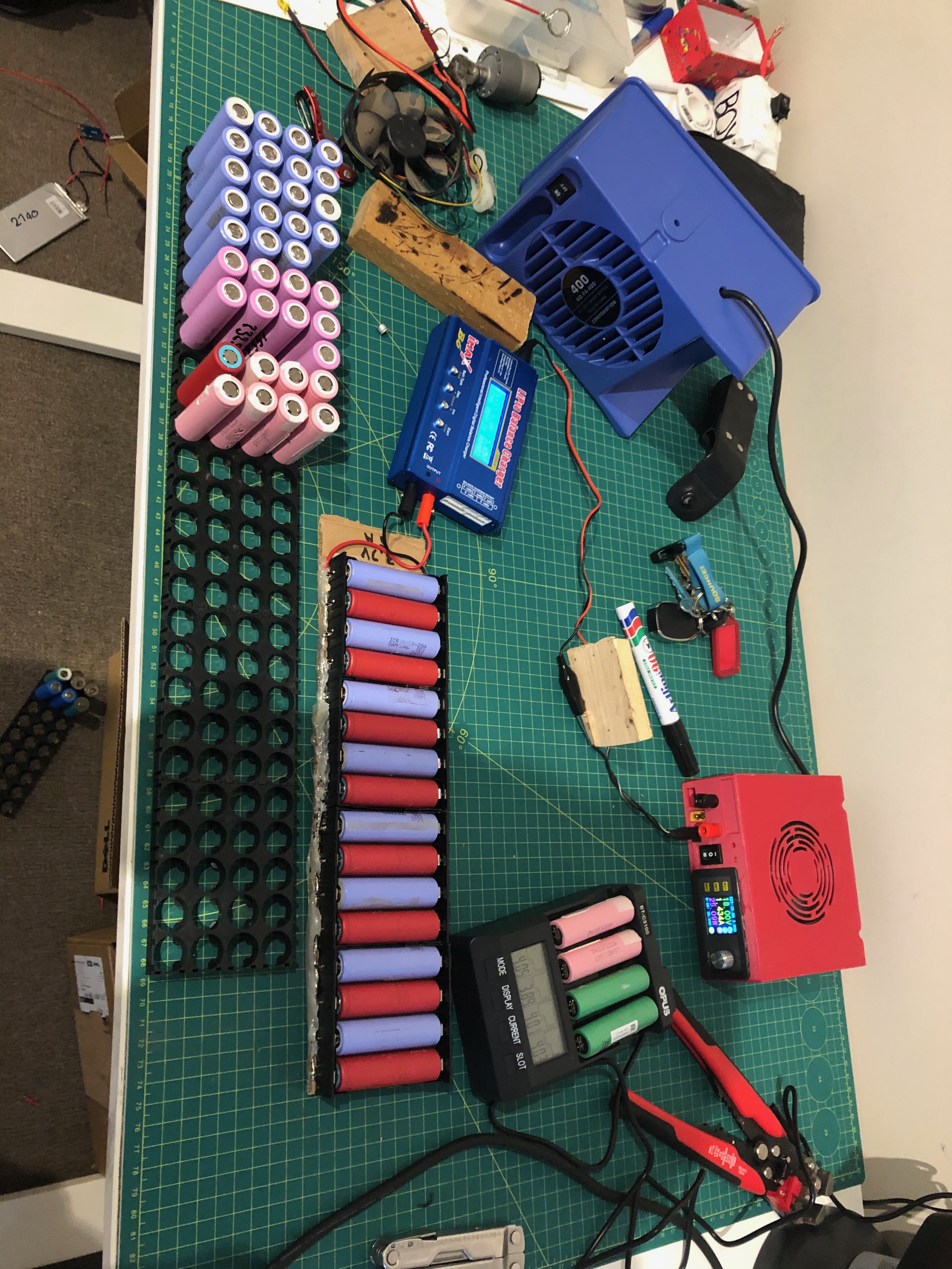 Lithium-ion cells and charging equipment on a workbench